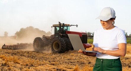 Poster - Female farmer with laptop controls an autonomous tractor on a smart farm