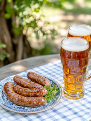 Wall Mural - beer on the table and appetizing German sausages. AI generative.