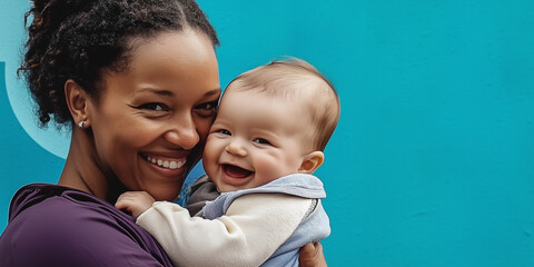 happy woman smiling and holding her baby in city background, there is space for text block 