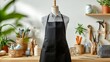 © WE.ARE.AI - Tailor mannequin with black apron in artisan workshop. Surrounded by sewing tools, fabrics, and plants, creating a creative workspace ambience.
