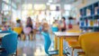 © masyastadnikova - Close up of children's school chairs in the background of a blurry classroom with colorful tables and bookshelves