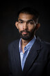 © Pituk - Portrait of bearded handsome man in black suit in a pensive mood and looking at camera.