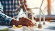 © Людмила Мазур - A man is drawing a wind turbine on a table. Concept of creativity and innovation, as the man is using a crayon to draw the turbine