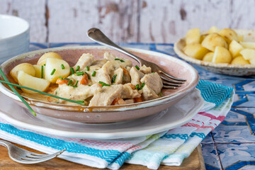 Wall Mural - Pork in creamy mushroom sauce with boiled baby potatoes