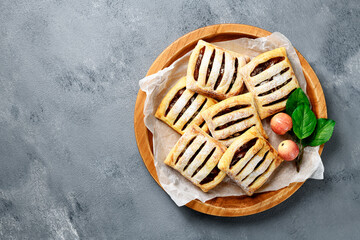 Homemade puff pastry pies filled with caramelized apples . top view