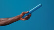 © crazyass - Baton Exchange in Relay Race, close-up of baton firmly held in receiver's hand, showcasing precision and teamwork during a crucial moment in the race