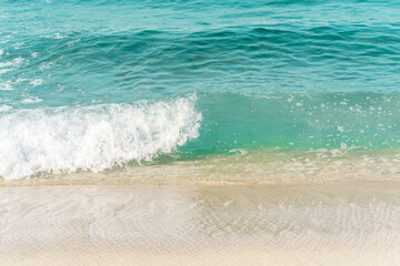 Clear aqua ocean waves heading towards the shore