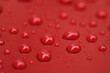 © GCapture - Closeup rain drops on red car with hydrophobic coating