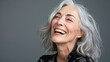 © Kowit - A woman with gray hair is smiling and laughing