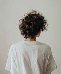 Poster - Young man with curly hair wearing a white shirt indoors at home