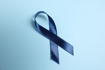 Canvas Print - Dark blue ribbon on color background, top view. Prostate cancer awareness