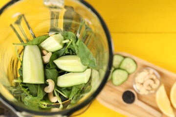 Poster - Modern blender with ingredients for smoothie on yellow wooden table, top view