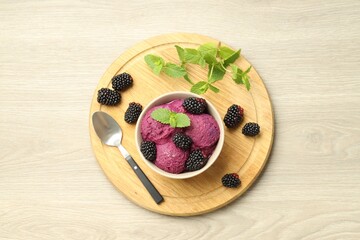 Wall Mural - Delicious blackberry sorbet with fresh berries in bowl and spoon on table, top view