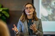 © Tanu - A woman wearing glasses is seen presenting to a group, illustrating her points with clarity and confidence, AI generated