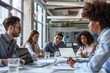 © Tanu - A group of colleagues discussing ideas around a table. AI generated