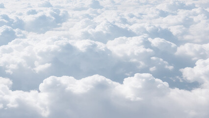 Wall Mural - White Clouds from above. Aerial view of the fluffy white cloud on blue sky. Top view from an airplane over white clouds in a blue sky. High in the Heavens.