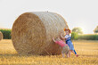 © famveldman - Child in wheat field with German bread