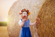 © famveldman - Child in wheat field with German bread
