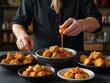 © buena17 - Chef Drizzling Sauce Over Golden Chicken Nuggets in a Rustic Kitchen