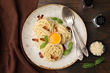 Wall Mural - Delicious pasta Carbonara served on wooden table, top view