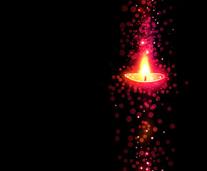 Diwali oil lamp with glowing bokeh light effect on a dark background.