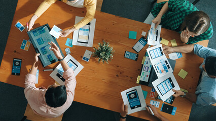 Top view of developer and designer shake hand together at meeting. Software developer handshake and working together with programmer to develop Ux Ui desifn for mobile phone interface. Convocation.