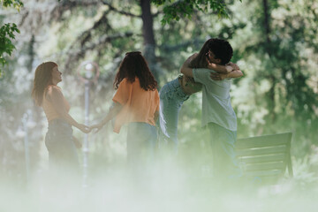 Poster - Group of young adults spending quality time together in a park, enjoying a sunny day and creating strong friendships.