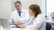 © flipper1971 - Supervisor checks the work of a female doctor