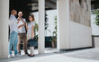 © qunica.com - Three business professionals in casual attire having a discussion and collaboration meeting outside an office building.