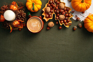Wall Mural - Autumn fall composition. Flat lay pumpkins, nuts in leaf-shaped plate, coffee cup, decorative candle with pine cones. Cozy, vintage style.