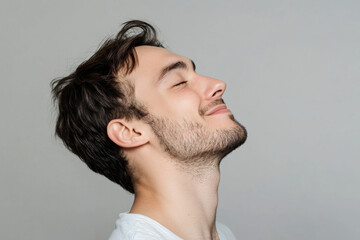 Wall Mural - A close up of a man's face with her eyes closed