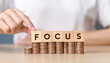 © Saddha Visual - Focus management concept. hand put focus word on wooden block cube