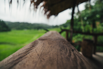 Wall Mural - Wood on the balcony of a house by the rice field