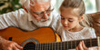 © Andres Mejia - Grandfather teaching granddaughter how to play guitar at home