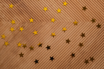 Wall Mural - abstract new year and christmas corrugated background in beige color with gold stars.