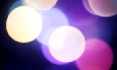 Wall Mural - Abstract bokeh background with blurry lights in purple, blue and yellow colors.