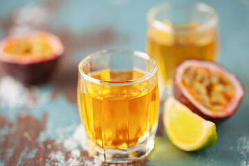 Wall Mural - Passion Fruit Liqueur in shot glasses. Tropical natural drink