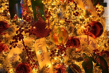 A Christmas tree, decorated with colorful balls, ribbons, ornaments and lights