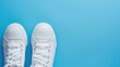 © dekor - White Sneakers on Blue Background