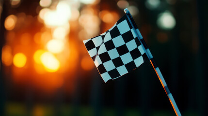 A close-up of a checkered flag waving in the sunset, symbolizing victory and competition in racing events.