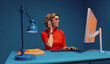 © Jacob Lund - Agent with headset typing on keyboard in colour blocking office setting