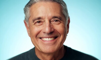 Poster - Portrait of a happy senior man smiling at the camera over blue background