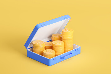 Top view of suitcase with stack of coin on yellow background