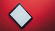© luluk - Black tablet computer with a blank white screen placed on a red surface.