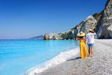 Wall Mural - a summer tourist couple walks down the beautiful beach of lalaria at skiathos island, sporades, gree