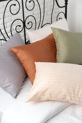 Wall Mural - Striped Pillows on a Bed With Black Metal Headboard