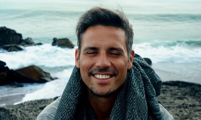 Canvas Print - Portrait of a smiling man on the beach with sea in the background