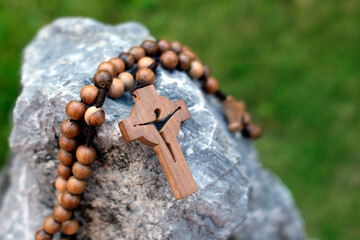 Poster - Rosary on a rock. Religious symbol of chritianity.