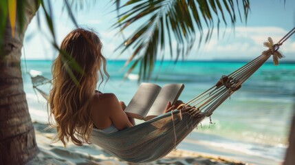 Wall Mural - A woman relaxing in a hammock by the beach, reading a book