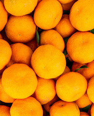 orange mandarin background of fresh juicy tangerines close up, vegan friut conception of citrus